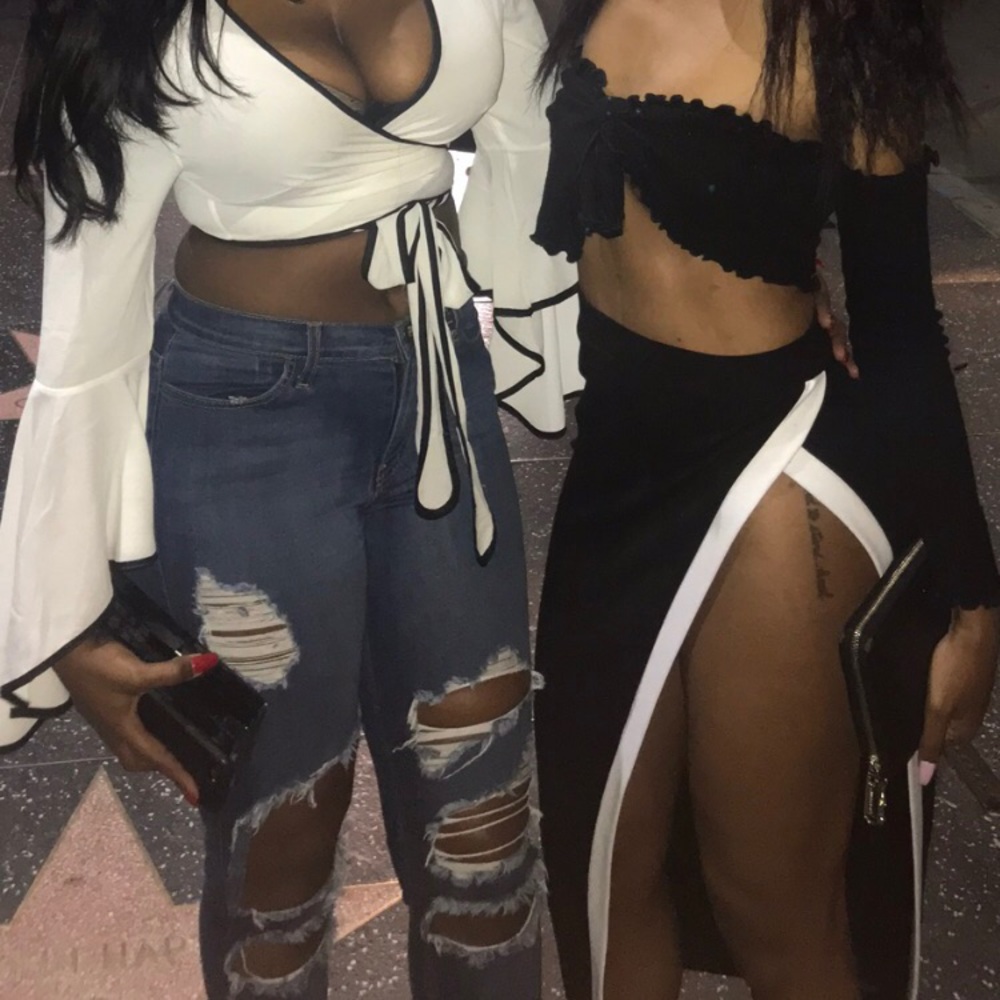 Black skirt with white thigh high split.